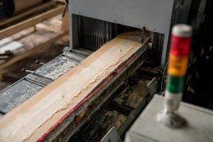 Sawing wood with laser marks, close-up